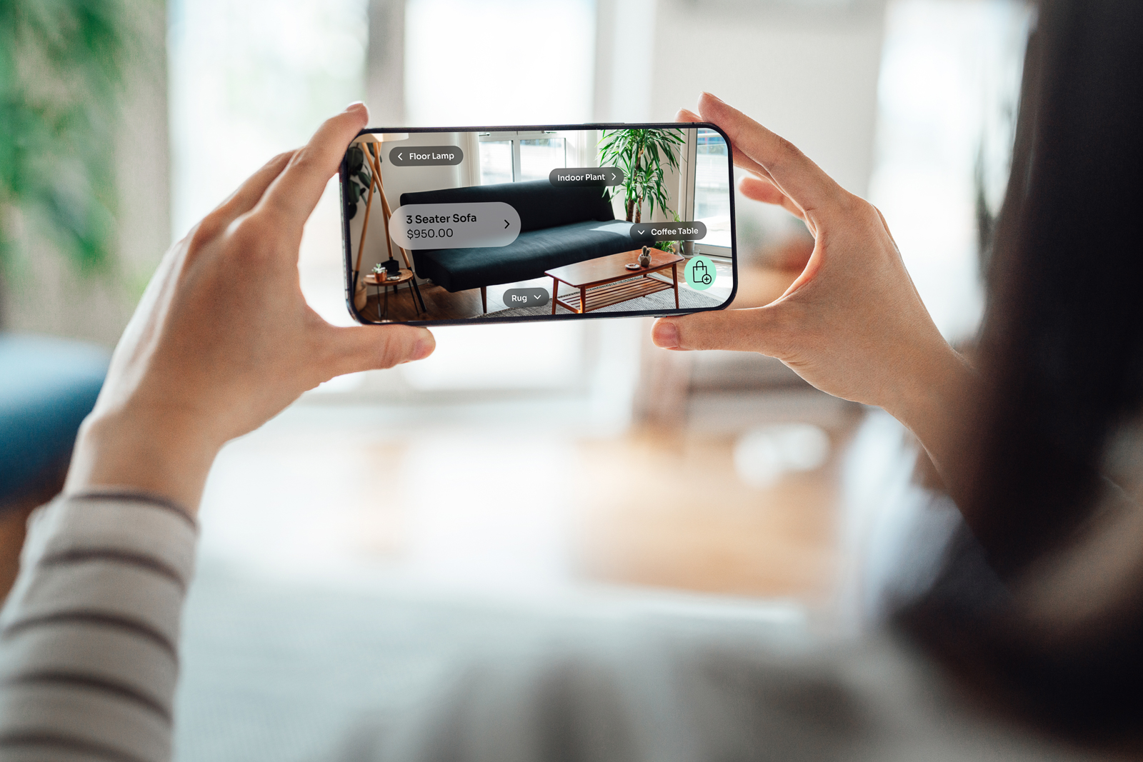 Person using phone to visualize what a couch would look like in their room