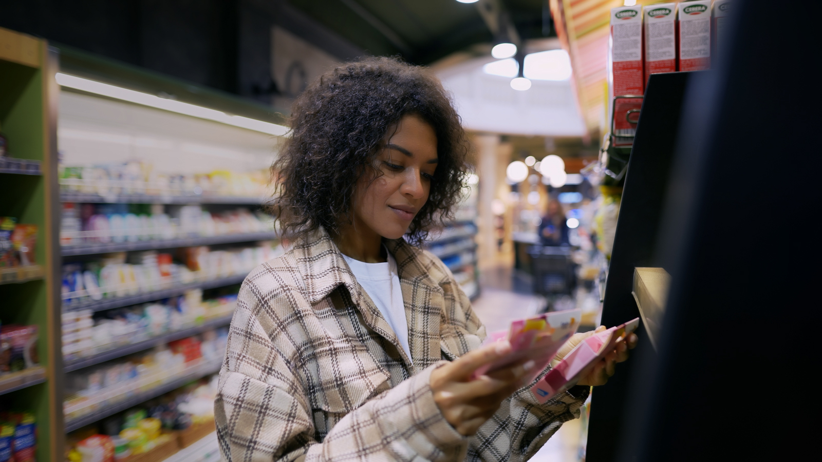 Woman comparing packages in store